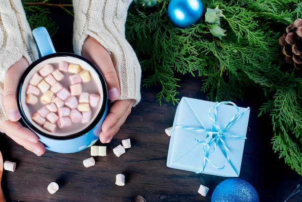 istock little girl holds hot chocolate mug wit marshmallow 867767156