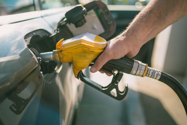 car refueling on petrol station. man pumping gasoline oil. this photo can be used for automotive industry or transportation concept - biodiesel imagens e fotografias de stock