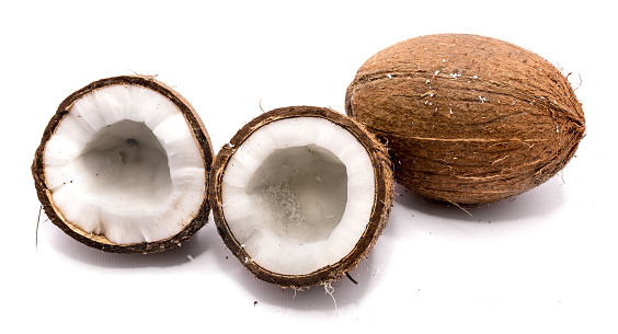 One whole coconut and two halves isolated on white background