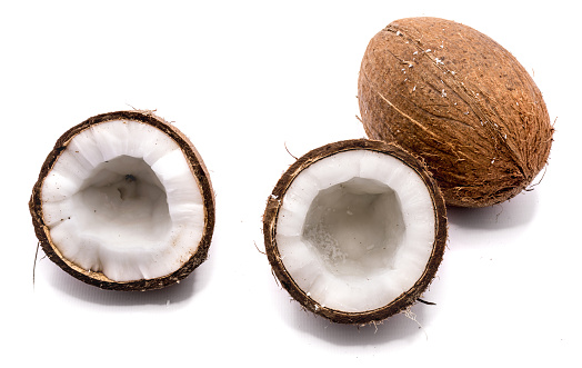 One whole coconut and two halves isolated on white background