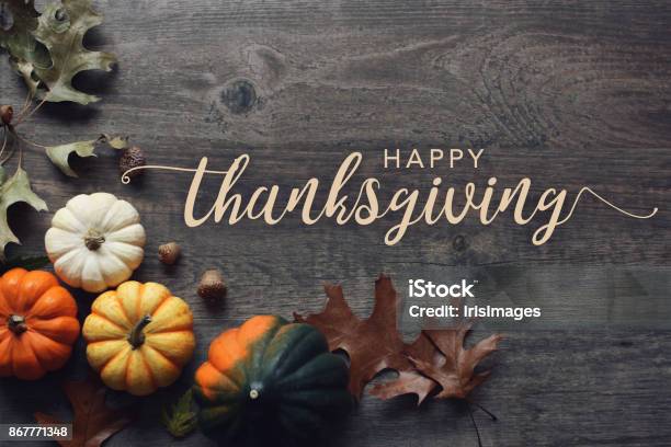 Happy Thanksgiving Greeting Text With Pumpkins Squash And Leaves Over Dark Wood Background Stock Photo - Download Image Now