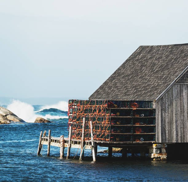 Lobster traps stacked on a wharf in Peggy's Cove, Nova Scotia.