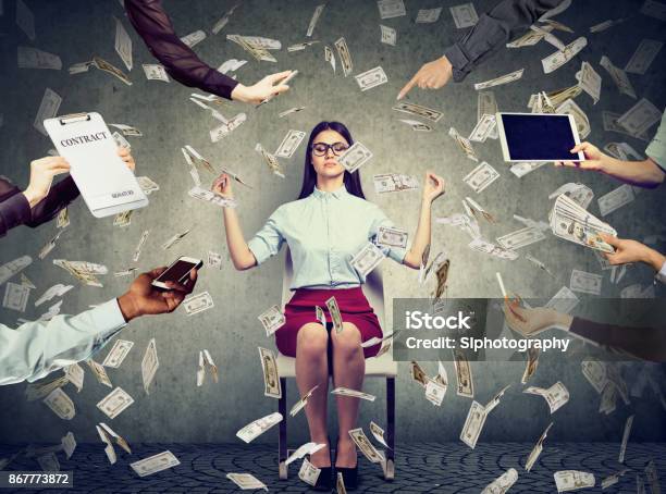 Young Business Woman Is Meditating To Relieve Stress Of Busy Corporate Life Under Money Rain Stock Photo - Download Image Now