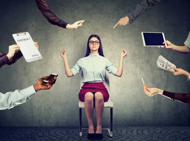 Photo of Young business woman is meditating to relieve stress of busy corporate life