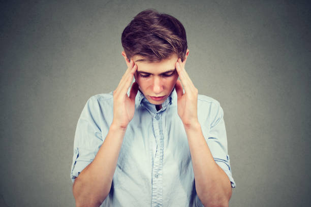 istock Closeup portrait sad young handsome man with worried stressed face expression looking down 867773962