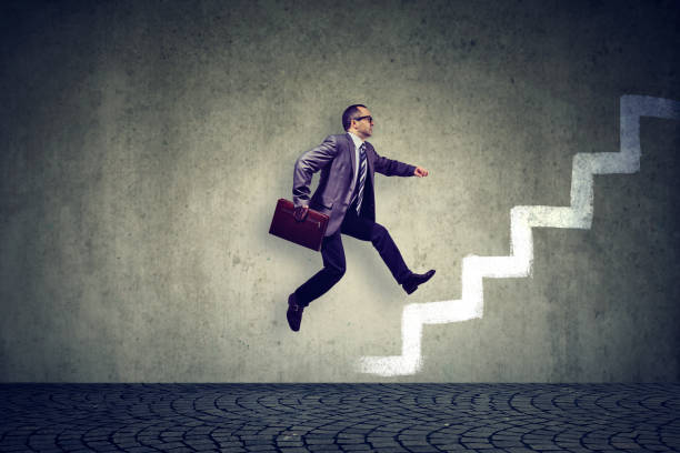 istock Ambitious mature business man climbing a staircase 867774002