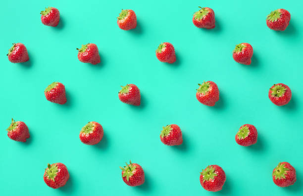 Colorful pattern of strawberries Colorful pattern of strawberries on blue background. From top view strawberry photos stock pictures, royalty-free photos & images