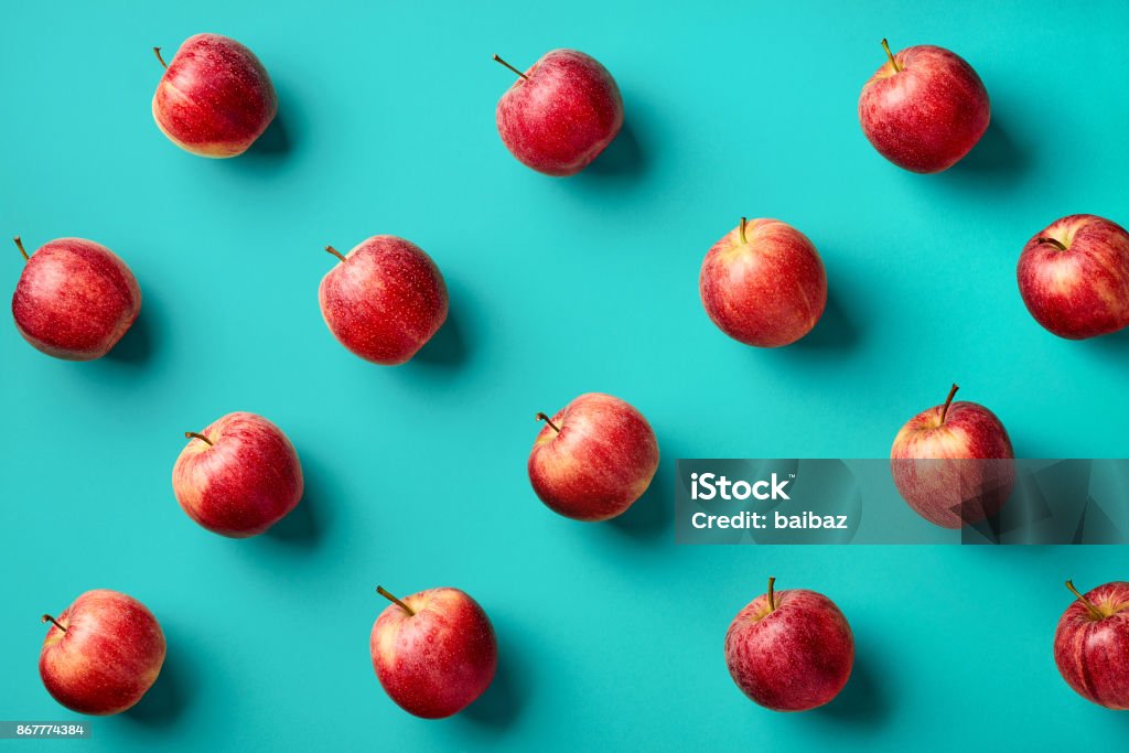 Colorful pattern of apples Colorful fruit pattern of fresh red apples on blue background. From top view Apple - Fruit Stock Photo