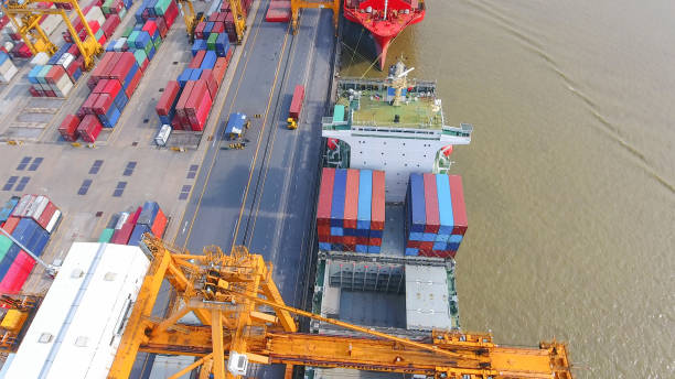 istock Logistics and transportation of Container Cargo ship and Cargo working crane bridge in shipyard 867774450