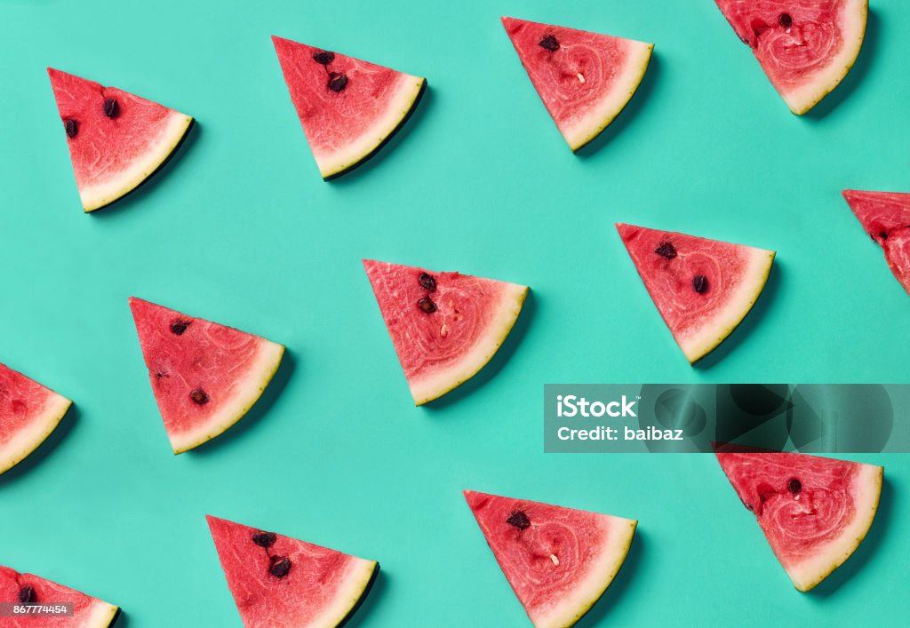 Colorful pattern of watermelon slices Colorful fruit pattern of fresh watermelon slices on blue background. From top view Watermelon Stock Photo