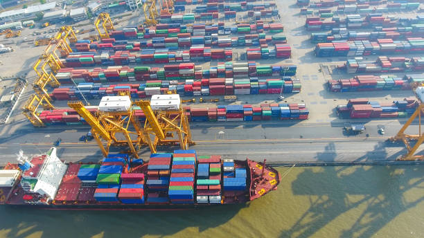 istock Logistics and transportation of Container Cargo ship and Cargo working crane bridge in shipyard 867774744
