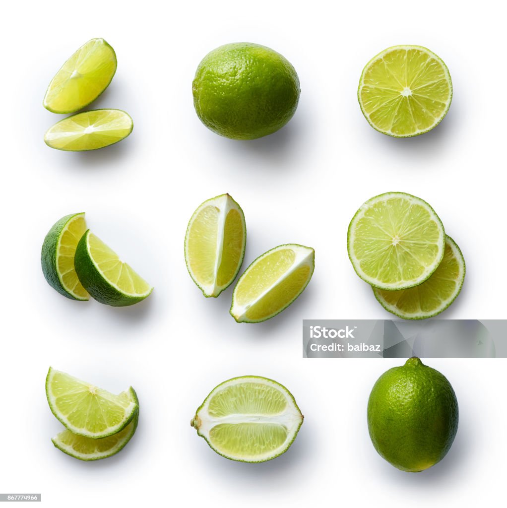 Fresh lime isolated on white background Set of fresh whole and cut lime and slices isolated on white background. From top view Lime Stock Photo