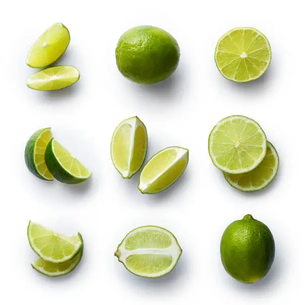 Set of fresh whole and cut lime and slices isolated on white background. From top view