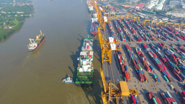 istock Logistics and transportation of Container Cargo ship and Cargo working crane bridge in shipyard 867775210