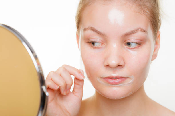istock Woman removing facial peel off mask. 867775860