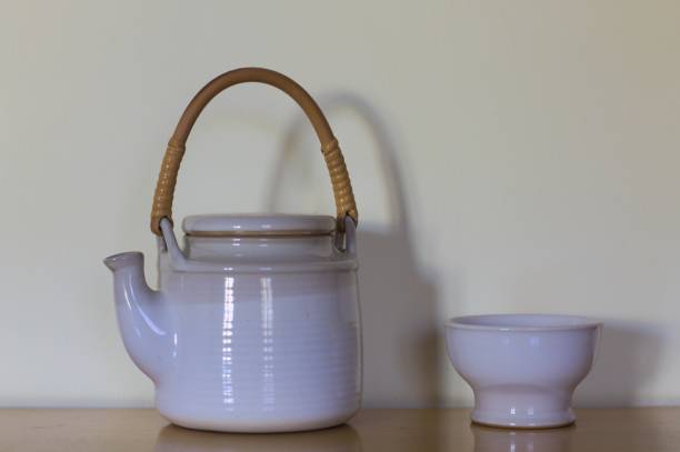 istock White teapot with wooden handle and a white cup (Pesaro, Italy) 867777158