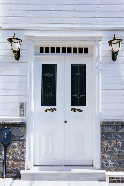 istock White wooden door with two latterns 867779486