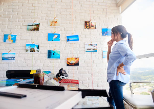 Hispanic Woman Working As Photographer Checking Images In Studio