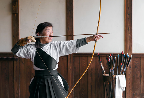 Senior Japanese archer taking part in the traditional Japanese sport Kyudo. Okayama, Japan. May 2017