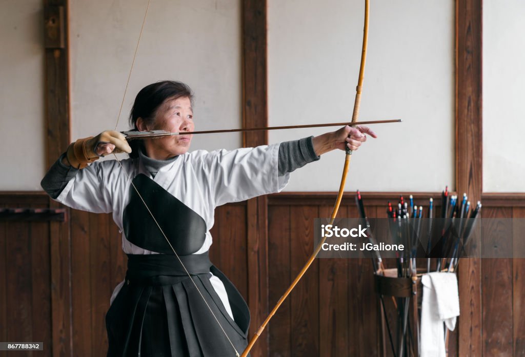 Senior Japanese archer Senior Japanese archer taking part in the traditional Japanese sport Kyudo. Okayama, Japan. May 2017 Archery Stock Photo