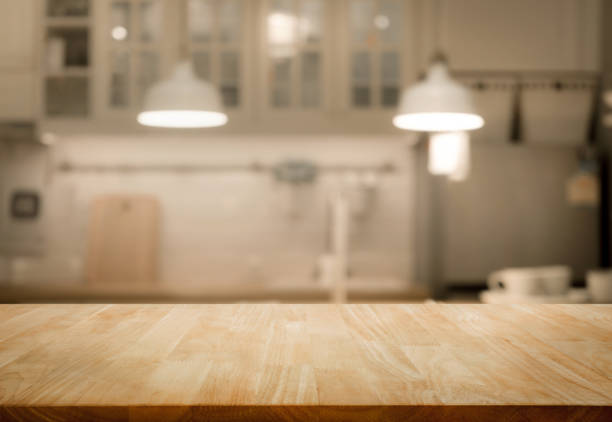Wood table top on blur kitchen wall room background stock photo