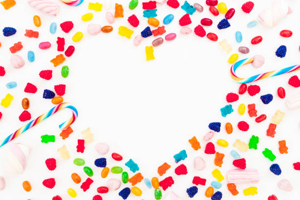 istock Heart made of colored bright candy isolated on white background. Flat lay, top view 867802438