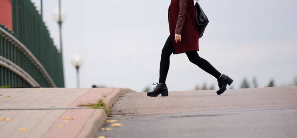istock Woman walking home on zebra crossing 867803436