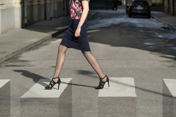Woman and zebra crossing, shades causes 3d effect illusion