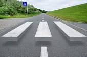 Empty zebra crossing, shades causes 3d effect illusion to decrease speed