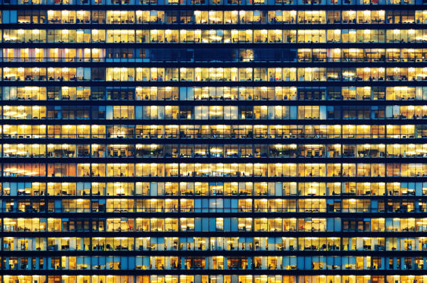 istock Office workers working late in major office building 867803966