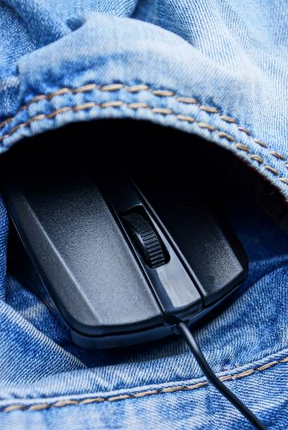 istock black computer mouse with a wire in the pocket of blue trousers 867820208