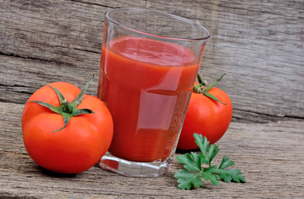 istock Tomatoes juice in a glass on table 867827276