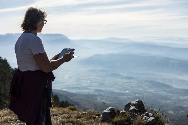 istock Mature Woman Using Digital Tablet in The Mountains 867832844