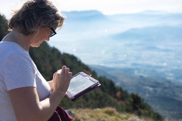 istock Mature Woman Using Digital Tablet in The Mountains 867832956