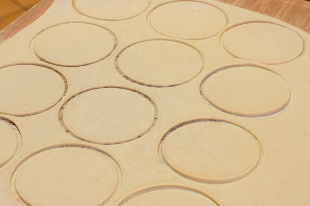 istock Rings in dough for pierogi on wooden board. 867836072