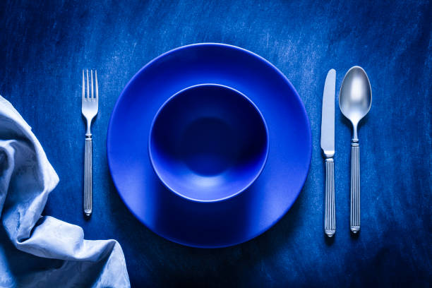 istock Blue toned place setting shot from above on dark background 867839422