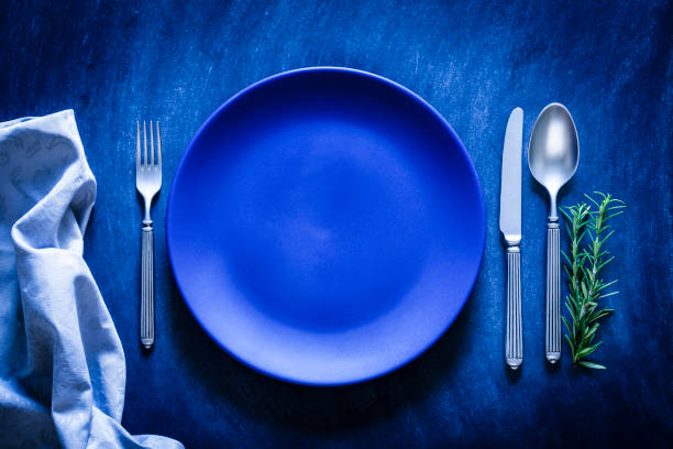 istock Blue toned place setting shot from above on dark background 867839680