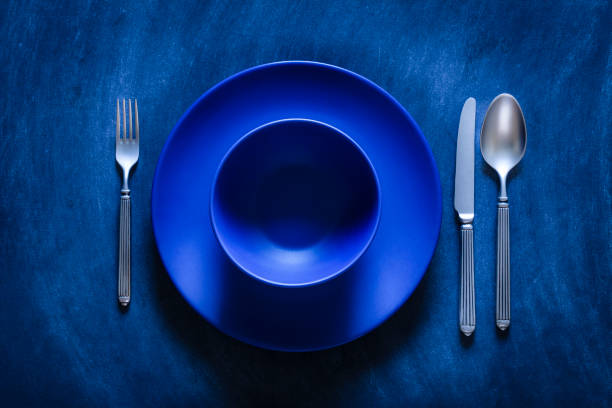 istock Blue toned place setting shot from above on dark background 867839688