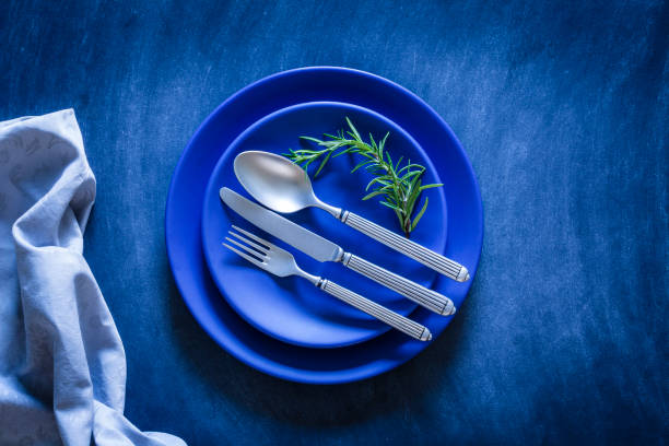 istock Blue toned place setting shot from above on dark background 867841892