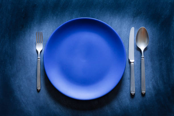 istock Blue toned place setting shot from above on dark background 867842008