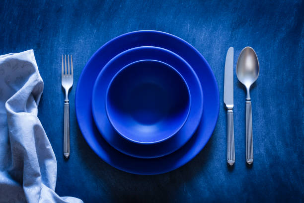 istock Blue toned place setting shot from above on dark background 867842030