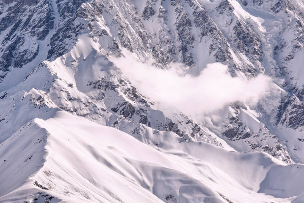 istock Mountain covered with snow with a cloud on its side, beautiful winter outdoor background 867845242