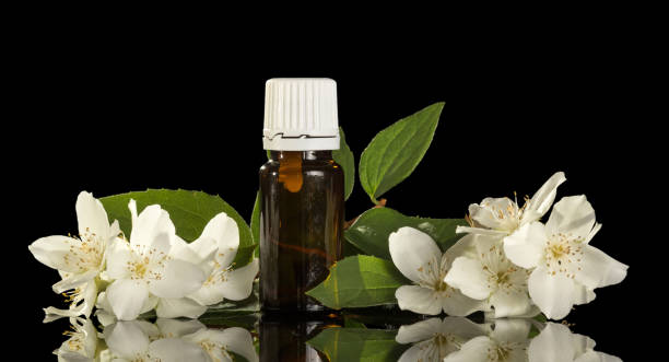 istock Liquid with floral scent, for smoking electronic cigarette and jasmine flowers isolated on black 867852328