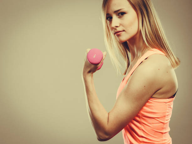 istock Fitness woman exercising with dumbbells. 867852502