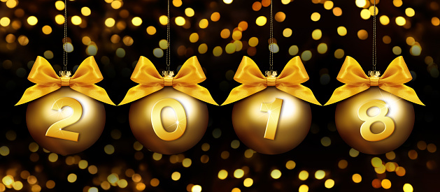happy new year christmas balls with golden ribbon bow and 2018 text on golden blurred lights background