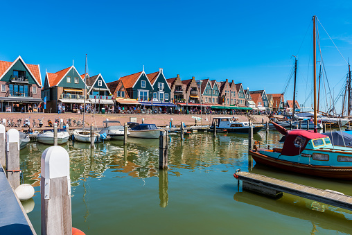 Volendam, Netherlands - June 18, 2017: View on the town center of Volendam, Netherlands. Volendam is a popular tourist attraction in the Netherlands, well known for its old fishing boats and the traditional clothing still worn by some residents.