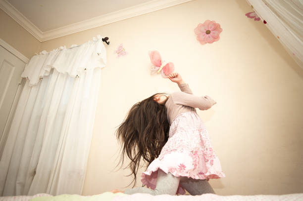 istock Little girl dancing on her bed 867855996