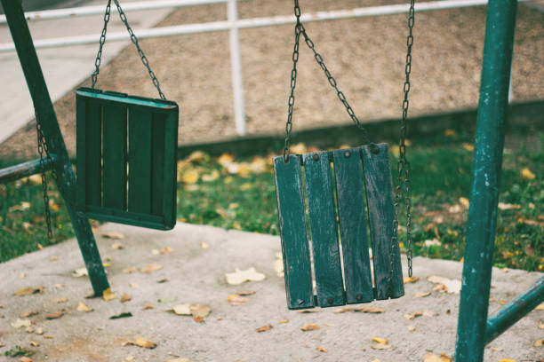 Broken Swings at the playground in the park Swing, Breaking, Chain, Crack Cocaine, Equipment breaker slide stock pictures, royalty-free photos & images