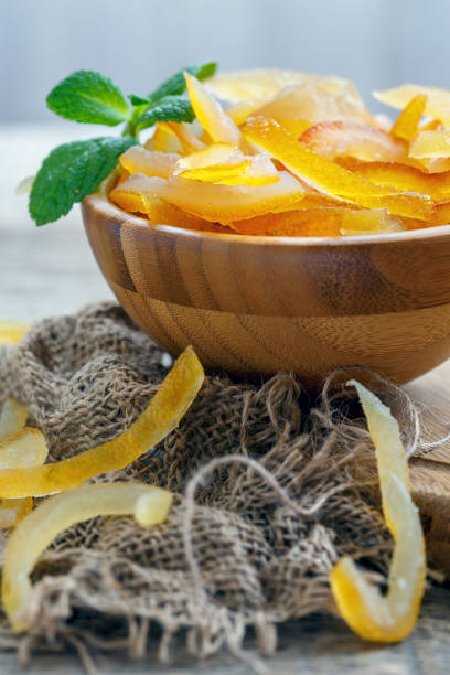 istock Candied citrus fruit in a wooden bowl and mint. 867858722