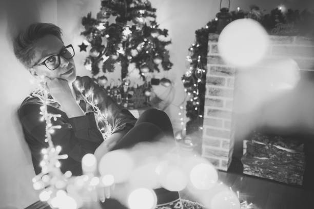 Woman hanging christmas lights at home